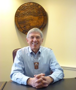 Lt. Gov. Byron Mallott sits at his desk, beneath the state seal Feb. 26. mallott heads up a new administration transboundary mines working group. (Ed Schoenfeld, CoastAlaska News)