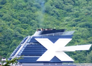 A Celebrity Cruise Line ship sails into Juneau in 2012 with emissions coming out of its stack. New pollution-control equipment will reduce the plume. (Ed Schoenfeld/CoastAlaska News)