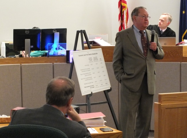 Economist Gregg Erickson explains to the jury his projections for Simone Kim's potential lifetime income as attorney Mark Choate listens and Superior Court Judge Philip Pallenberg views an overhead projection. (Photo by Matt Miller/KTOO News)
