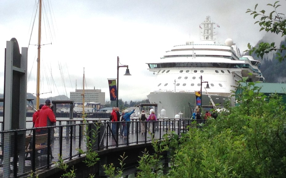 Tourists walk toward the cruise ship Radiance of the Seas, docked at Juneau's waterfront. (Photo by Ed Schoenfeld,/CoastAlaska News)